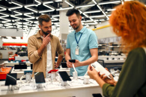 A brand representative in an electronics store, educating his client to make a more informed decision.