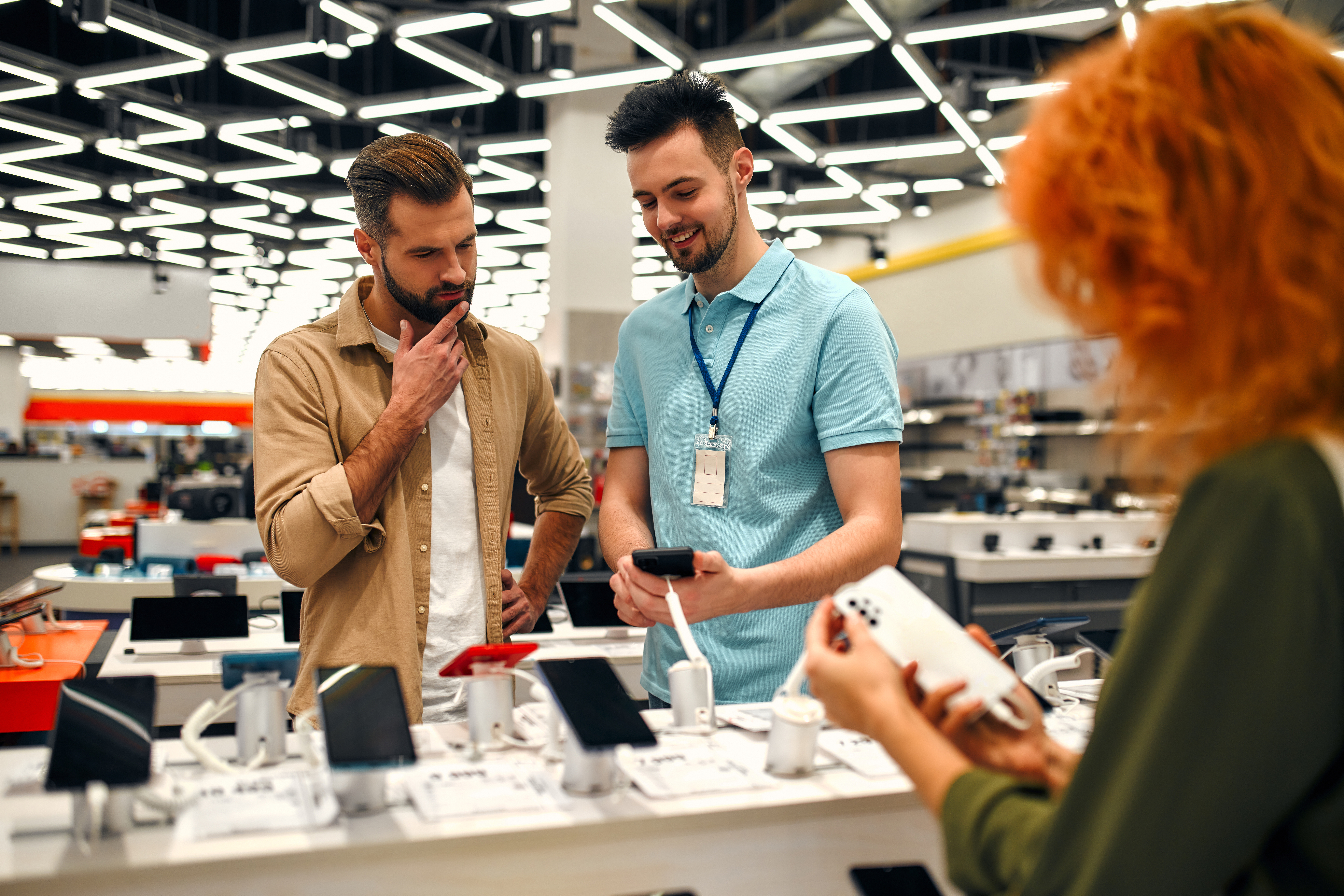 A brand representative in an electronics store, educating his client to make a more informed decision.